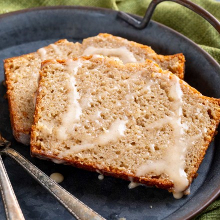 Quick bread recipe made with real eggnog, warming spices and rum, topped off with a sweet cinnamon rum glaze!  This holiday eggnog bread is perfect as a dessert, or holiday breakfast.  Makes one large loaf, or 3 smaller loaves. #eggnog #bread #quickbread #holidaybaking #christmas #bakingrecipe #dessert #breakfast