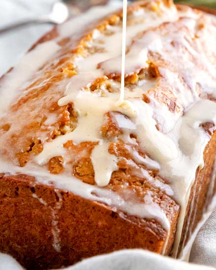 Quick bread recipe made with real eggnog, warming spices and rum, topped off with a sweet cinnamon rum glaze!  This holiday eggnog bread is perfect as a dessert, or holiday breakfast.  Makes one large loaf, or 3 smaller loaves. #eggnog #bread #quickbread #holidaybaking #christmas #bakingrecipe #dessert #breakfast