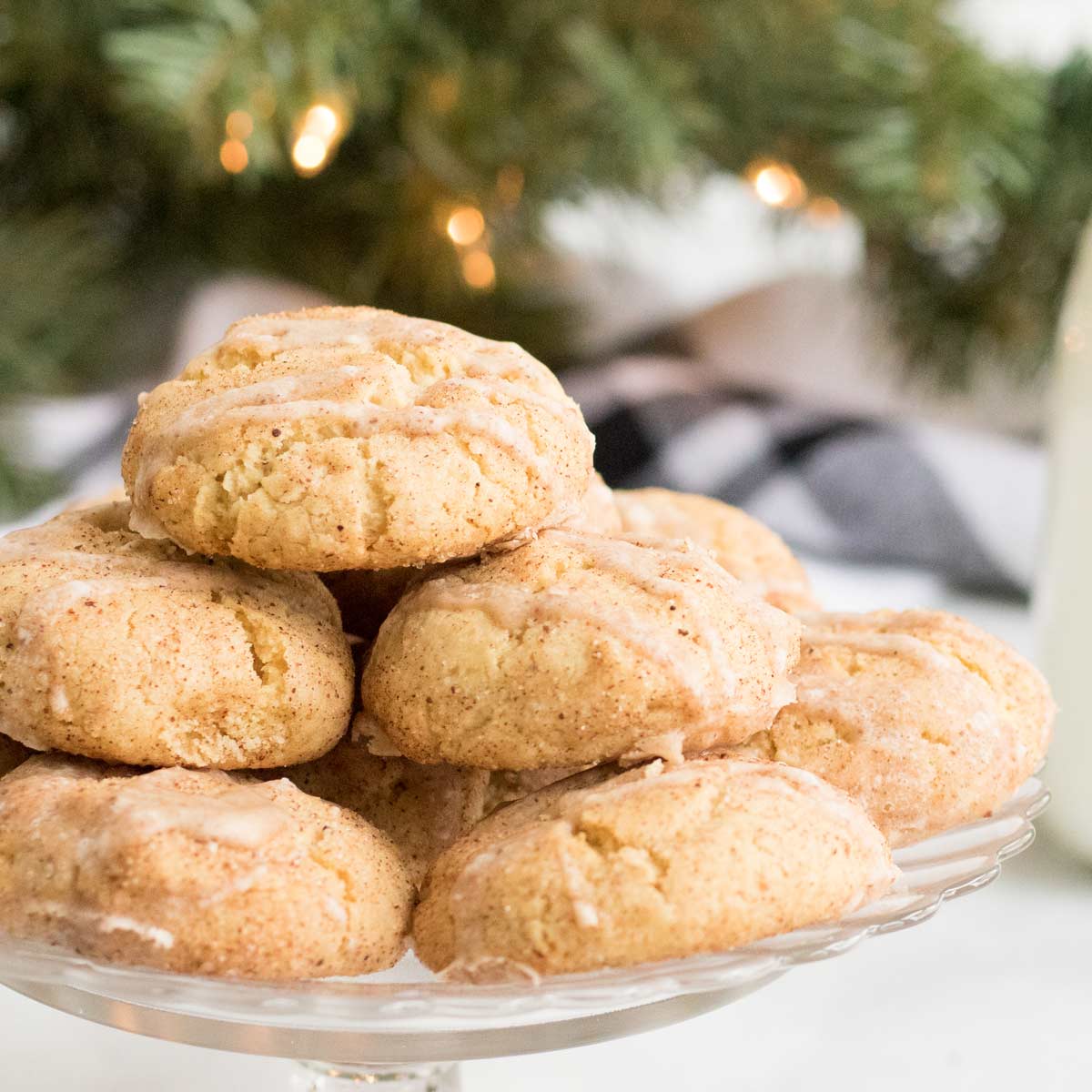 Classic soft and chewy snickerdoodle cookies made with a fun holiday twist... eggnog!  Filled with warm spices, actual eggnog, and drizzled with a sweet eggnog glaze! #cookies #dessert #baking #holiday #christmas #eggnog #snickerdoodle #cookieswap