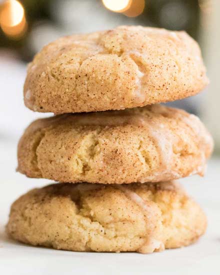 Classic soft and chewy snickerdoodle cookies made with a fun holiday twist... eggnog!  Filled with warm spices, actual eggnog, and drizzled with a sweet eggnog glaze! #cookies #dessert #baking #holiday #christmas #eggnog #snickerdoodle #cookieswap