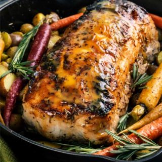 This Maple Mustard Roasted Pork Loin is SO moist and flavorful, you'll definitely want seconds! A simple brine gives the pork such great flavor and texture. Perfect for a holiday or weekend dinner! #porkloin #pork #roasted #brine #maple #mustard #holidaydinner #weekenddinner #easyrecipe
