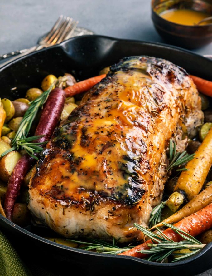 Perfect roasted pork loin recipe in cast iron pan with vegetables