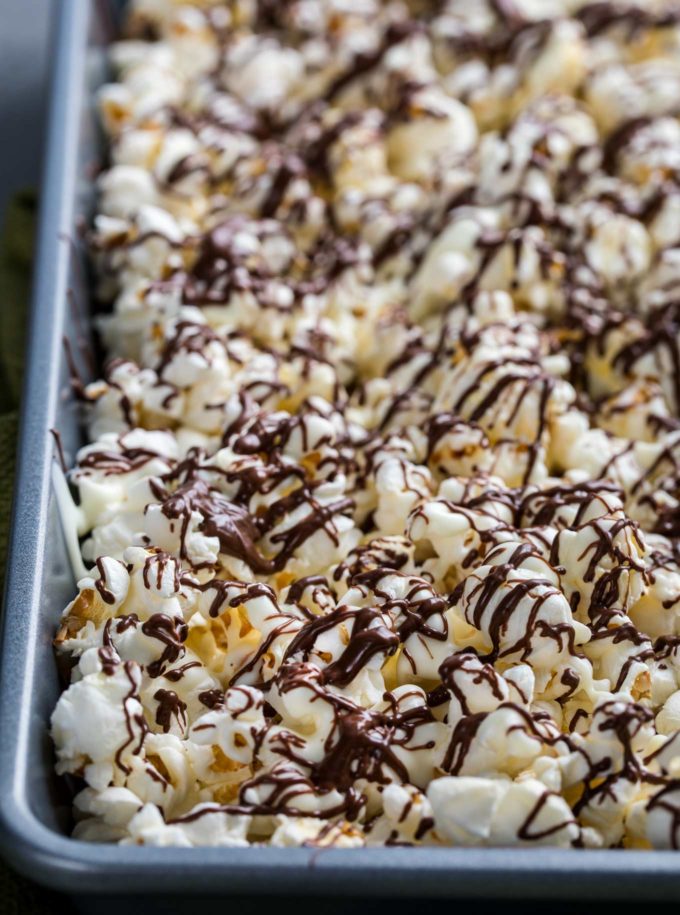 Chocolate covered popcorn made with both white and dark chocolate.  This easy, 5 minute snack recipe is the perfect combination of sweet and salty! #snack #popcorn #chocolate #easyrecipe #zebrapopcorn #popcornrecipe 