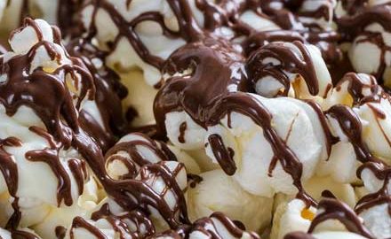 Chocolate covered popcorn made with both white and dark chocolate.  This easy, 5 minute snack recipe is the perfect combination of sweet and salty! #snack #popcorn #chocolate #easyrecipe #zebrapopcorn #popcornrecipe 