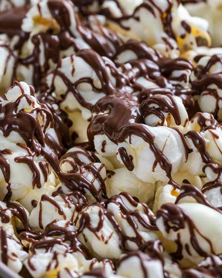 Chocolate covered popcorn made with both white and dark chocolate.  This easy, 5 minute snack recipe is the perfect combination of sweet and salty! #snack #popcorn #chocolate #easyrecipe #zebrapopcorn #popcornrecipe 