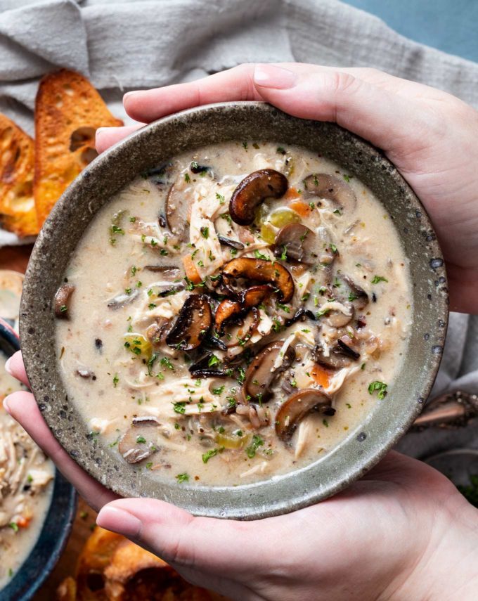 Holding a bowl of wild rice soup