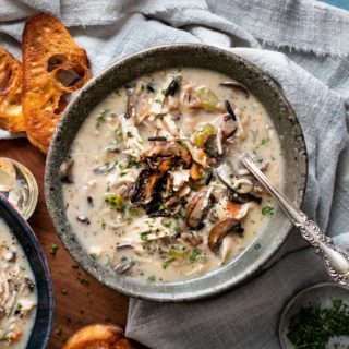 Hearty and ultra comforting, this Chicken and Wild Rice Soup is full of tender chicken and veggies, a creamy broth, nutty wild rice, and topped with more golden brown mushrooms! Stovetop, Slow Cooker and Instant Pot directions! #soup #chicken #wildrice #mushrooms #souprecipe #instantpot #slowcooker #crockpot #stovetop #dinner
