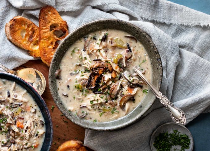 Hearty and ultra comforting, this Chicken and Wild Rice Soup is full of tender chicken and veggies, a creamy broth, nutty wild rice, and topped with more golden brown mushrooms!  Stovetop, Slow Cooker and Instant Pot directions! #soup #chicken #wildrice #mushrooms #souprecipe #instantpot #slowcooker #crockpot #stovetop #dinner