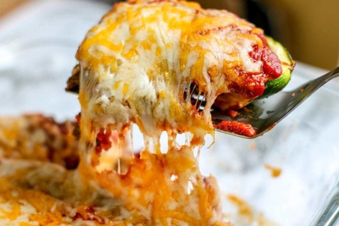 Spatula with enchilada zucchini boats and gooey cheese