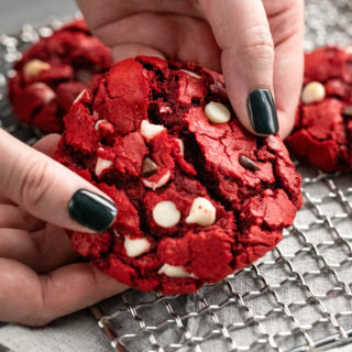 These Red Velvet Cake Mix Cookies are made using just 4 simple ingredients, and are on the cooling rack in 20 minutes - including prep time! Great for Valentine's Day or when you need a quick dessert. #redvelvet #cakemix #cookies #baking #dessert #dessertrecipe #easyrecipe #valentinesday