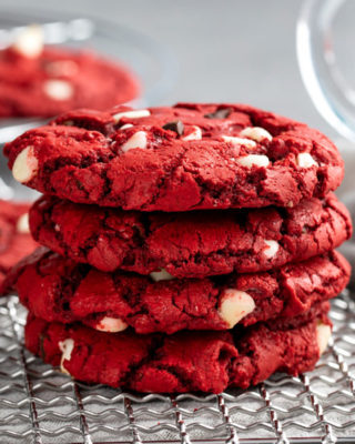 These Red Velvet Cake Mix Cookies are made using just 4 simple ingredients, and are on the cooling rack in 20 minutes - including prep time! Great for Valentine's Day or when you need a quick dessert. #redvelvet #cakemix #cookies #baking #dessert #dessertrecipe #easyrecipe #valentinesday