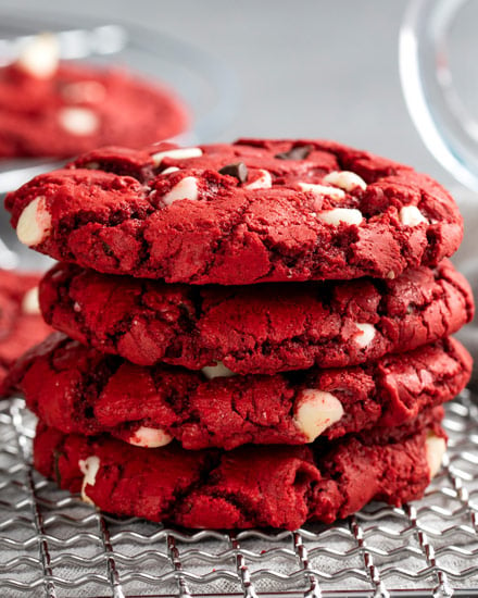 These Red Velvet Cake Mix Cookies are made using just 4 simple ingredients, and are on the cooling rack in 20 minutes - including prep time!  Great for Valentine's Day or when you need a quick dessert. #redvelvet #cakemix #cookies #baking #dessert #dessertrecipe #easyrecipe #valentinesday