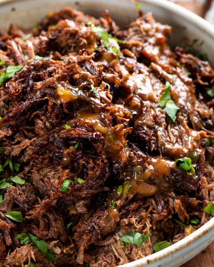 Truly melt-in-your-mouth tender and juicy, this beef barbacoa is loaded with bold flavors and ready for your tacos, burritos, bowls, or nachos!  Directions for pressure cooker, slow cooker, and the oven! #barbacoa #beef #mexican #shreddedbeef #cincodemayo #instantpot #pressurecooker #easyrecipe