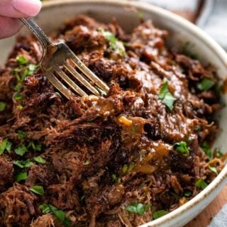 Truly melt-in-your-mouth tender and juicy, this beef barbacoa is loaded with bold flavors and ready for your tacos, burritos, bowls, or nachos! Directions for pressure cooker, slow cooker, and the oven! #barbacoa #beef #mexican #shreddedbeef #cincodemayo #instantpot #pressurecooker #easyrecipe