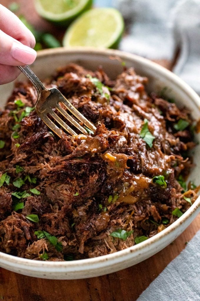 Truly melt-in-your-mouth tender and juicy, this beef barbacoa is loaded with bold flavors and ready for your tacos, burritos, bowls, or nachos!  Directions for pressure cooker, slow cooker, and the oven! #barbacoa #beef #mexican #shreddedbeef #cincodemayo #instantpot #pressurecooker #easyrecipe