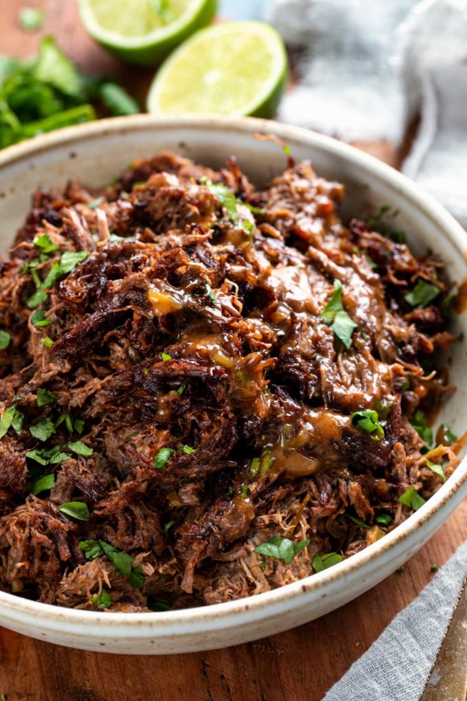 Truly melt-in-your-mouth tender and juicy, this beef barbacoa is loaded with bold flavors and ready for your tacos, burritos, bowls, or nachos!  Directions for pressure cooker, slow cooker, and the oven! #barbacoa #beef #mexican #shreddedbeef #cincodemayo #instantpot #pressurecooker #easyrecipe