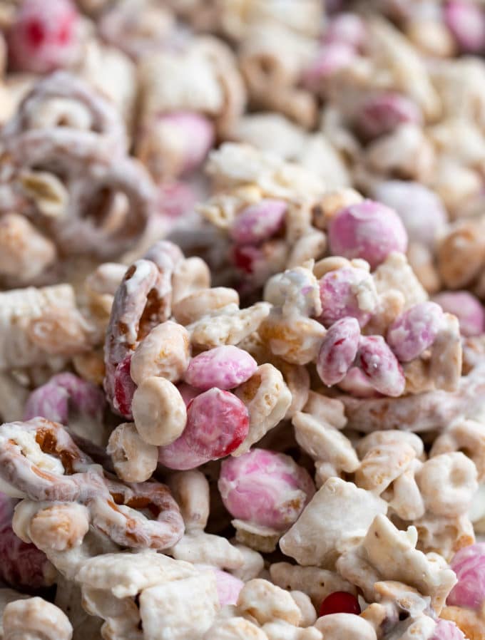 Mix of cereal, pretzels, peanuts, and m&m's, all tossed together with plenty of white chocolate. Perfect no bake recipe, made in less than 10 minutes!  Great for any holiday! #chexmix #snackmix #whitetrash #whitechocolate #trailmix #nobake #dessert #easyrecipe