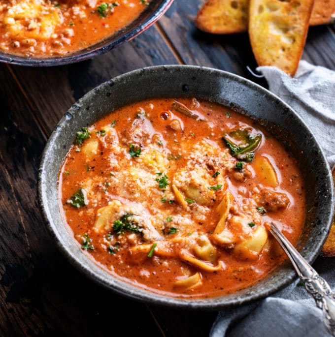 This sausage and tortellini soup is a bowl full of absolute comfort!  It's loaded with bold flavors, plenty of sausage and cheese-filled pasta, and there's only 5 minutes of pressure cooking time! #tortellini #soup #sausage #Italian #instantpot #pressurecooker #instapot #easyrecipe #dinner