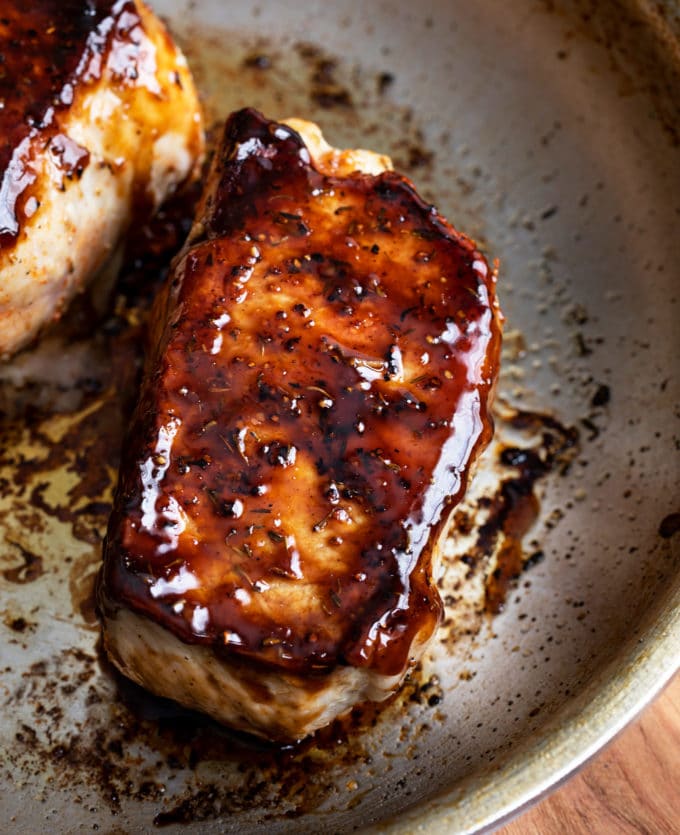 Baked pork chops with bourbon glaze in skillet