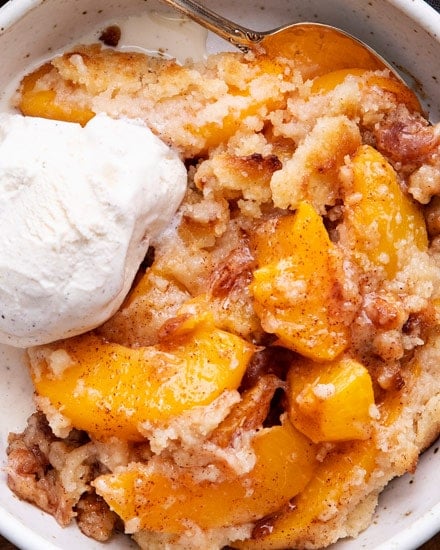 This peach cobbler is made with cinnamon sugared peaches, topped with a buttery shortbread-like topping, then baked to bubbly perfection!  Made with fresh, frozen or canned peaches, it's the perfect summer dessert recipe! #cobbler #peach #dessert #dessertrecipe #summer #peaches #southern #easydessert #easyrecipe