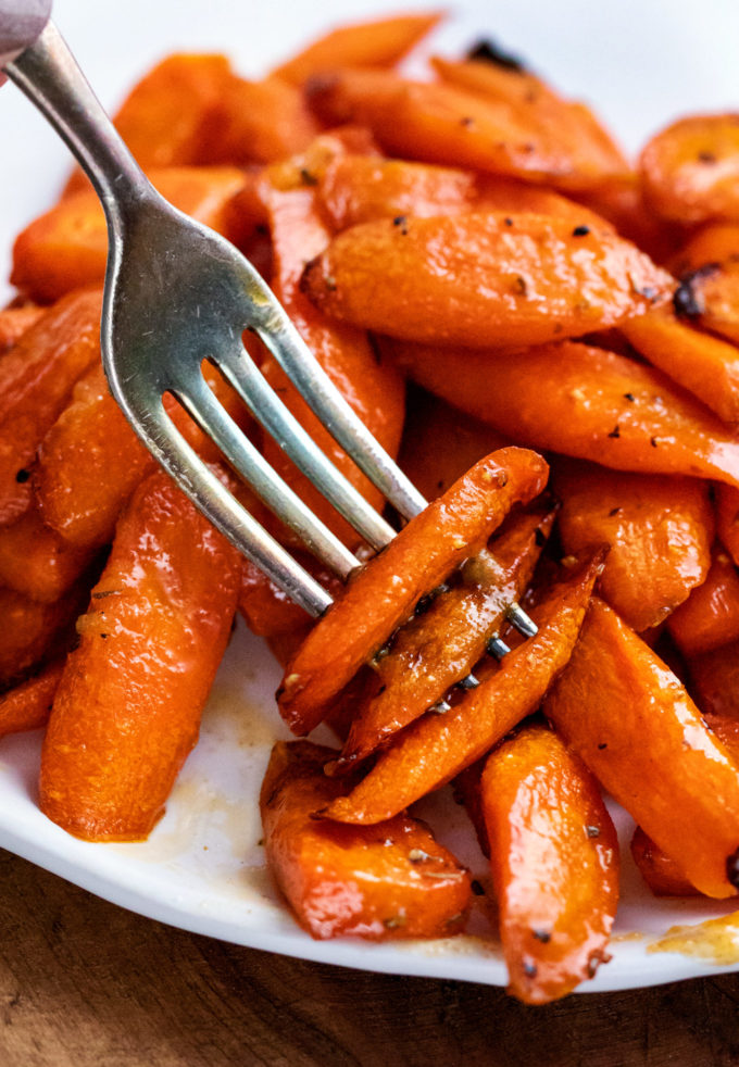 fork piercing 3 carrots on plate