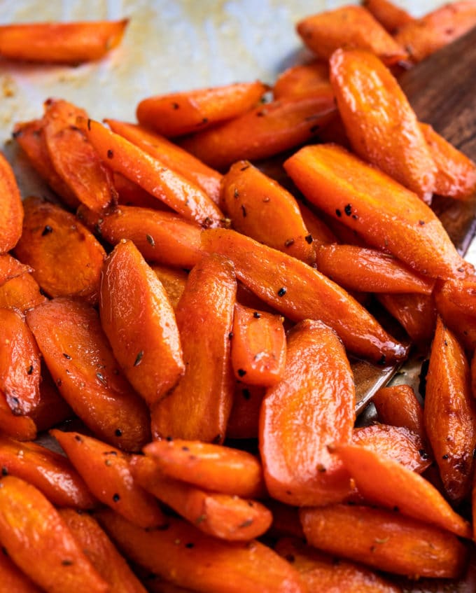 carrots on baking sheet with wooden spatula