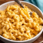 White bowl of mac and cheese with fork