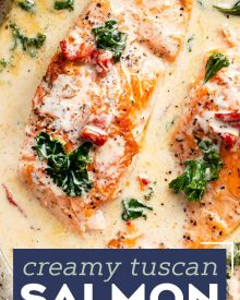 Tender salmon filets smothered in a rich garlic cream sauce filled with sun-dried tomatoes, kale and Parmesan cheese. Restaurant quality salmon, in 30 minutes! #salmon #seafood #fish #creamsauce #30minutemeal #easyrecipe #tuscan #Italian #sundriedtomatoes #kale #spinach