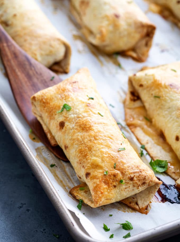 Baked chimichangas on baking sheet