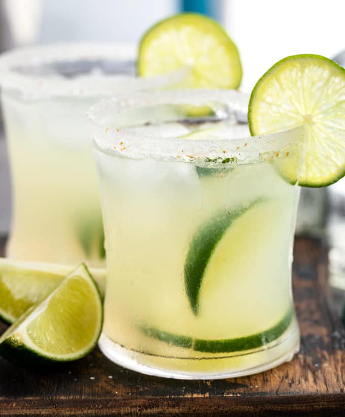 Fresh margaritas with lime wedges and salt rims