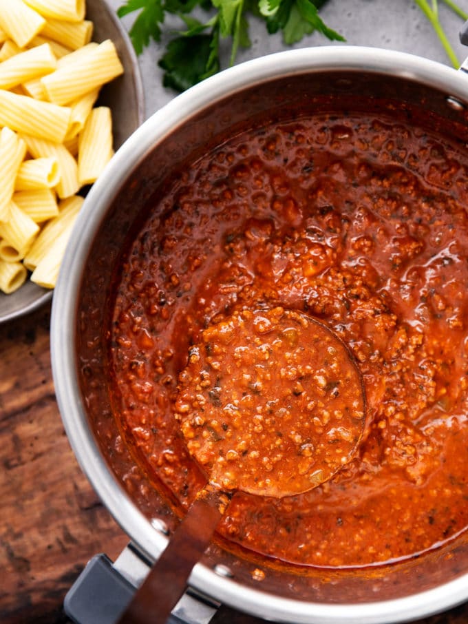 Ladle of bolognese sauce in pressure cooker