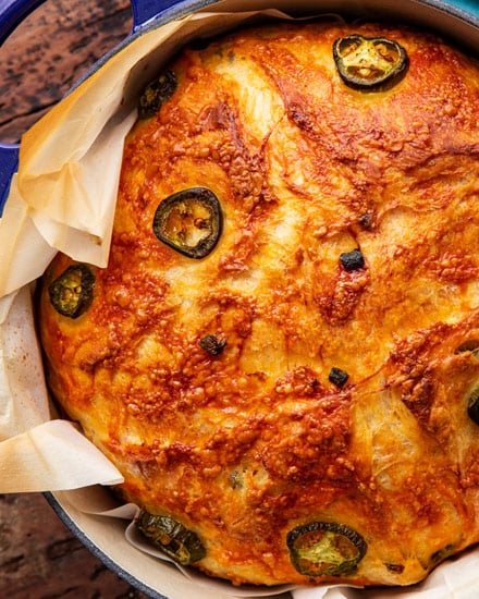 Jalapeno Cheddar Dutch Oven Bread is perfectly crusty on the outside, with a soft fluffy inside, and is made using simple ingredients. Deliciously savory with a bit of spice - perfect with a pat of butter, or for grilled cheese! #bread #homemade #dutchoven #baking #jalapeno #cheddar #pantry #noknead #baked #artisan