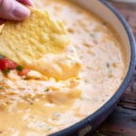 Chip with plenty of queso dip