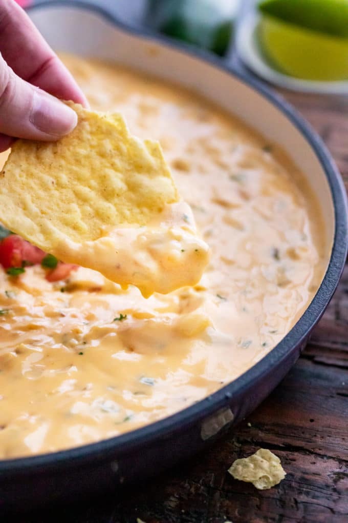 Chip with plenty of queso dip