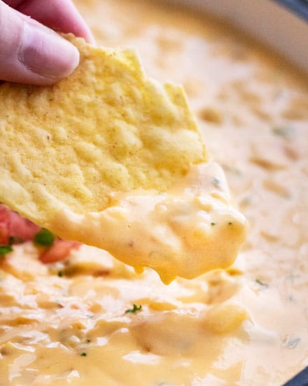 Smooth and silky queso dip, made using NO velveeta!  Packed with flavor, yet so easy to make, and party ready in just 20 minutes! #queso #dip #cheese #mexican #appetizer #party #cincodemayo #easyrecipe