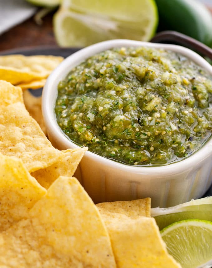 The best salsa verde is made with roasted tomatillos, peppers, onion and garlic! Smoky, a little spicy, slightly sweet, and perfect with salty chips.  Great for Cinco de Mayo, potlucks, enchiladas and more! #salsa #salsaverde #roasted #tomatillo #cincodemayo #chipsandsalsa #mexican #fiesta
