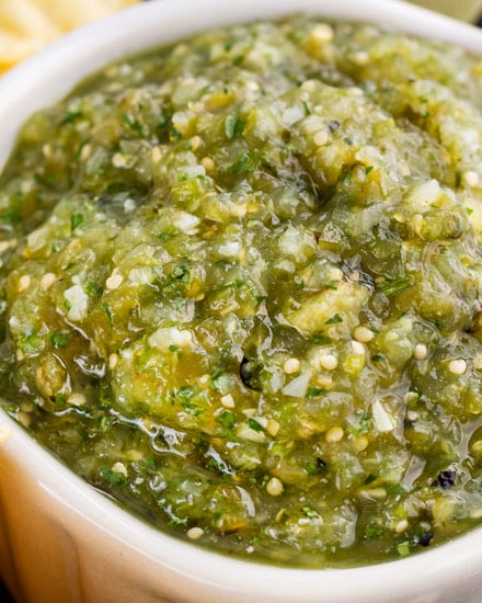 The best salsa verde is made with roasted tomatillos, peppers, onion and garlic! Smoky, a little spicy, slightly sweet, and perfect with salty chips.  Great for Cinco de Mayo, potlucks, enchiladas and more! #salsa #salsaverde #roasted #tomatillo #cincodemayo #chipsandsalsa #mexican #fiesta