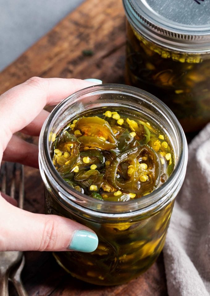 holding an open jar of cowboy candy