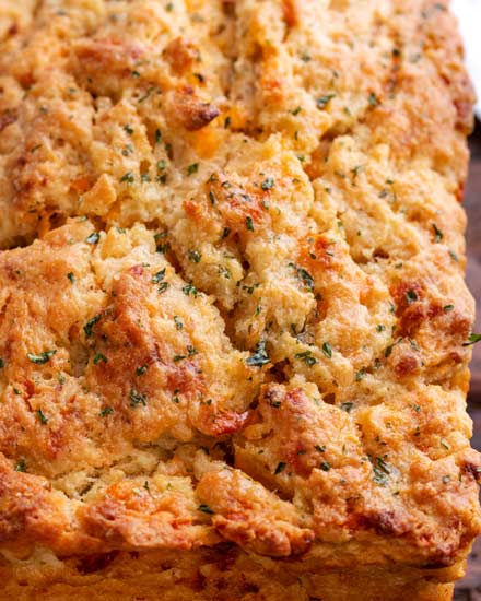 Whip up a loaf of this Garlic Cheddar Beer Bread in practically no time - and with NO yeast! No rising time, just mix and bake!  Tastes like Cheddar Bay biscuits, in loaf form! #beerbread #bread #garlic #cheddar #cheese #beer #baking #breadmaking #quickbread #pantry