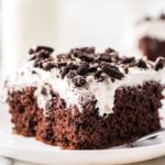 slice of chocolate poke cake on white plate