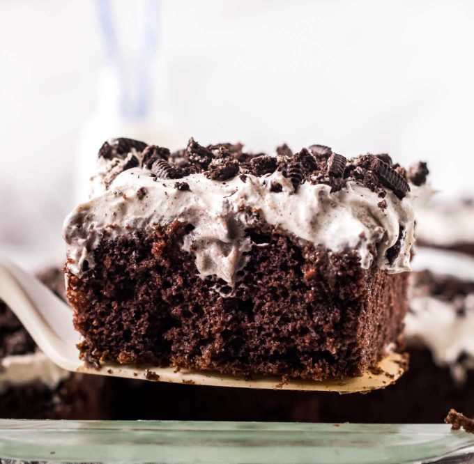 slice of chocolate oreo poke cake on spatula