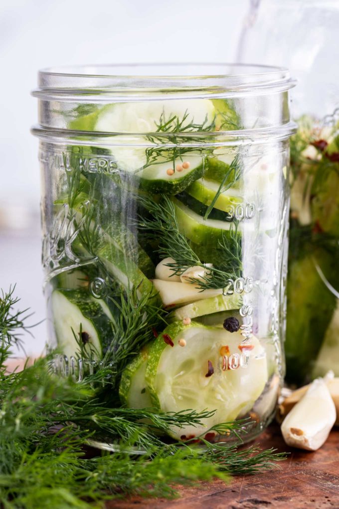 cucumber slices with dill in glass jar
