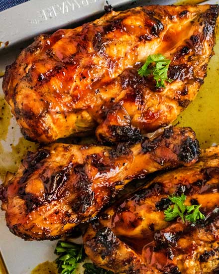 Hands down the BEST juicy Grilled BBQ Chicken!  With an optional quick brine and flavorful spice rub, this chicken is already bursting with flavor before you even add the bbq sauce! #chicken #bbq #barbecue #grilled #grilling #summer #grillout #cookout #dinner