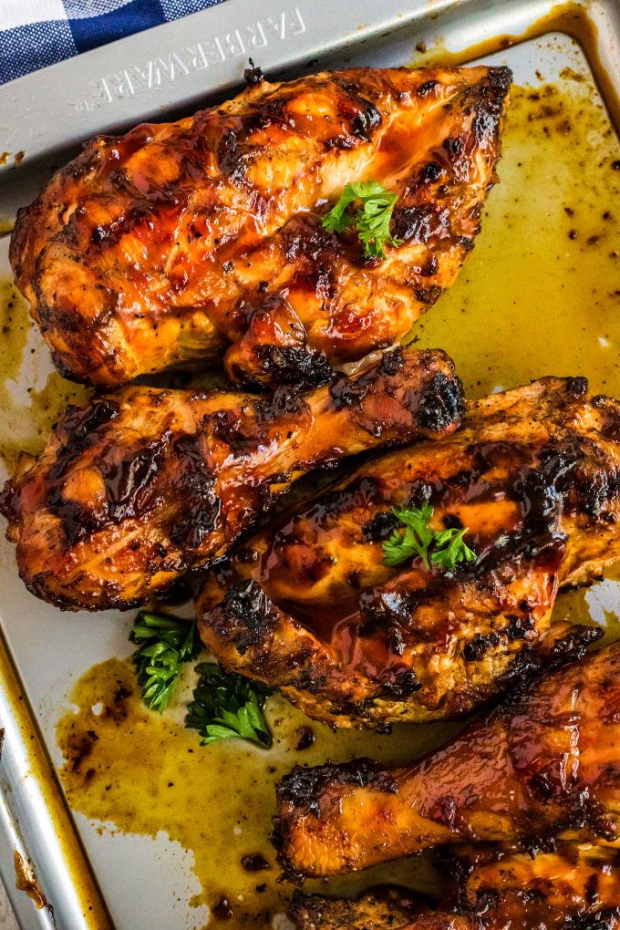 Hands down the BEST juicy Grilled BBQ Chicken!  With an optional quick brine and flavorful spice rub, this chicken is already bursting with flavor before you even add the bbq sauce! #chicken #bbq #barbecue #grilled #grilling #summer #grillout #cookout #dinner