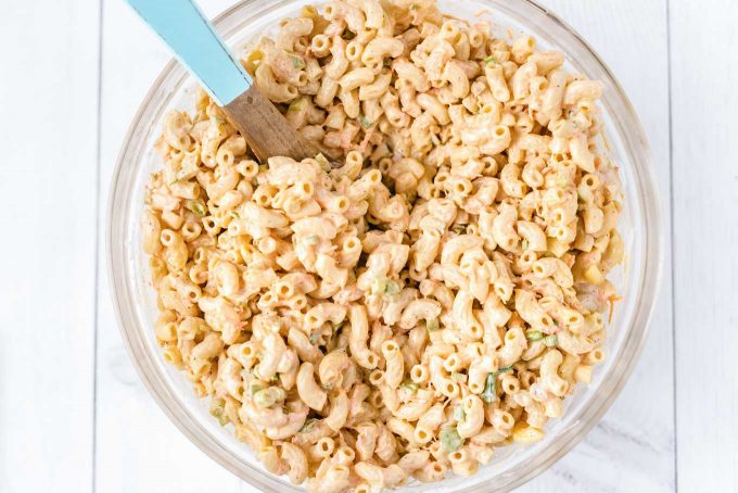 Bowl of macaroni salad with wooden spoon