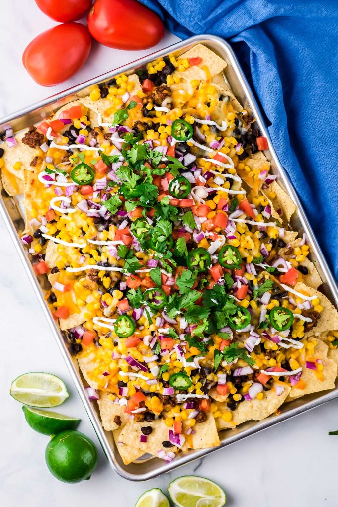 large baking sheet full of nachos