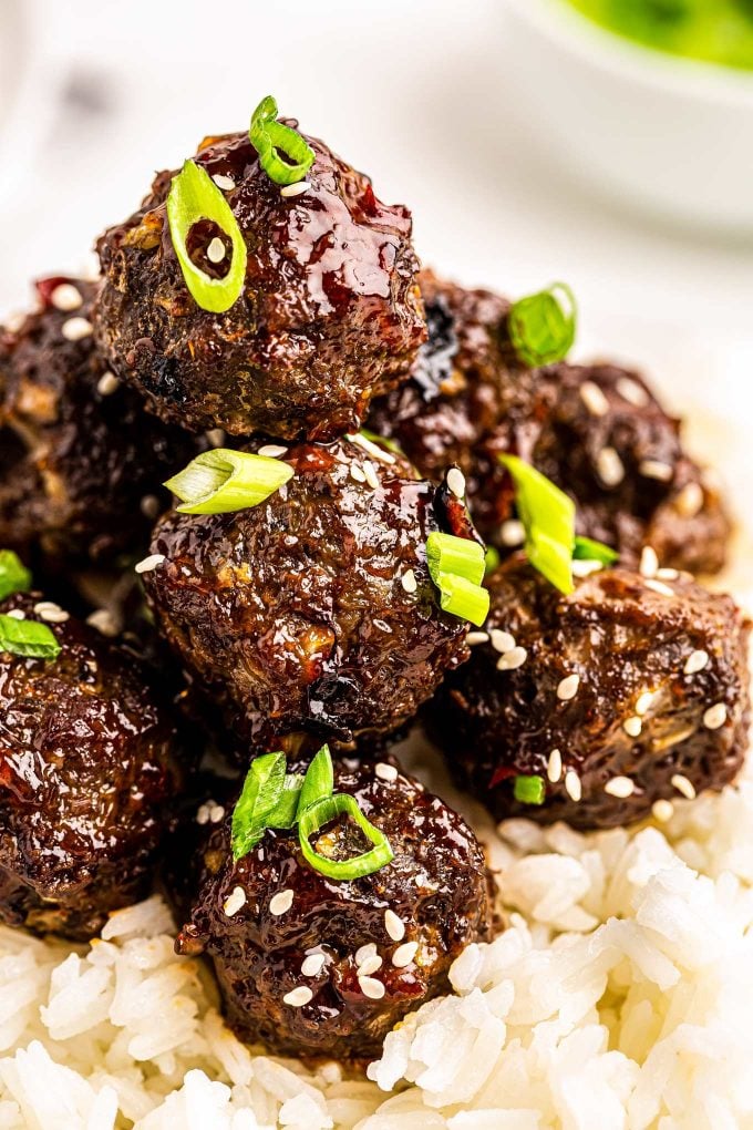 Tender baked meatballs loaded with fresh, bold, Thai flavors, smothered in a sticky sweet/savory sauce that is truly finger-lickin good!  Great over rice, in lettuce cups, or enjoyed with just a fork, they're the perfect party appetizer! #thai #meatballs #baked #asian #appetizer #partyfood