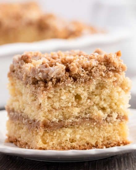 My favorite Sour Cream Coffee Cake is ultra moist and buttery, with a cinnamon streusel layer in the middle and on top, and drizzled with a sweet glaze. #coffeecake #crumbcake #sourcream #baking #breakfast #dessert #cinnamon #streusel #brunch