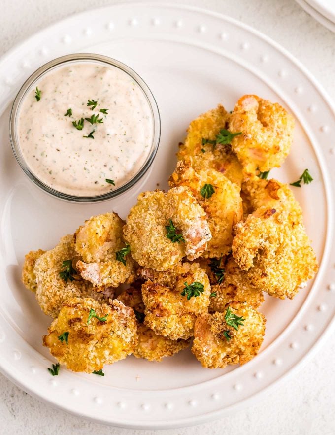 pile of fried shrimp on white plate with remoulade sauce