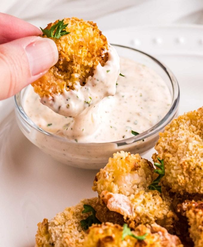 dipping fried shrimp in remoulade sauce